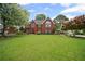 Classic brick home boasts a lush green lawn and inviting curb appeal at 6355 Stallion Dr, Cumming, GA 30040