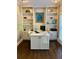 Bright home office features custom built-ins, a modern desk and dark hardwood flooring at 6355 Stallion Dr, Cumming, GA 30040