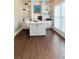 Bright home office with hardwood floors, built-in shelves, white trim, and ample natural light at 6355 Stallion Dr, Cumming, GA 30040