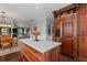 Spacious kitchen with a marble top island and a dining area and living room in the background at 6355 Stallion Dr, Cumming, GA 30040