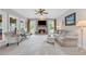 Bright living room featuring a fireplace and large windows that provide lots of natural light at 6355 Stallion Dr, Cumming, GA 30040