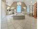 Spacious primary bathroom with large tub, walk-in shower, dual vanities, and unique architectural details at 6355 Stallion Dr, Cumming, GA 30040