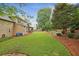 Expansive backyard with mature trees, green lawn, and lush landscaping at 6720 Wolford Ct, Johns Creek, GA 30097