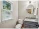 Bathroom with window for natural light and marble countertop at 6720 Wolford Ct, Johns Creek, GA 30097