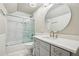 Clean bathroom features a shower-tub combination and grey vanity with countertop at 6720 Wolford Ct, Johns Creek, GA 30097