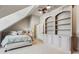 Cozy bedroom features built in shelves, carpet and ceiling fan at 6720 Wolford Ct, Johns Creek, GA 30097