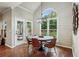 Dining room area with natural light from large window, wood floors, modern chandelier at 6720 Wolford Ct, Johns Creek, GA 30097