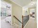 Bright hallway featuring neutral tones, carpet, and a view into two bedrooms at 6720 Wolford Ct, Johns Creek, GA 30097