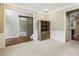 Hallway featuring hardwood floors, a sliding barn door and view of staircase with carpet at 6720 Wolford Ct, Johns Creek, GA 30097