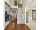 Hallway with wooden floors leads to an office, staircase, and living room with a sliding barn door at 6720 Wolford Ct, Johns Creek, GA 30097