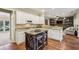 Well-lit kitchen with stone countertops, stainless appliances, island and bar seating at 6720 Wolford Ct, Johns Creek, GA 30097