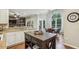 Kitchen features stone countertops, stainless appliances, bar seating, and an island at 6720 Wolford Ct, Johns Creek, GA 30097