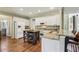Open kitchen features white cabinets, granite countertops, stainless appliances and a large island at 6720 Wolford Ct, Johns Creek, GA 30097