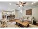 Spacious living room with wood floors adjacent to the open kitchen and breakfast bar at 6720 Wolford Ct, Johns Creek, GA 30097