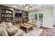 Inviting living room with a fireplace, built-in bookshelves, and a large window with lots of natural light at 6720 Wolford Ct, Johns Creek, GA 30097