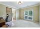 Bright office with large windows and a sliding barn door, perfect for remote work at 6720 Wolford Ct, Johns Creek, GA 30097