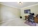 Comfortable office space with a television, desk, and sliding door, ideal for working remotely at 6720 Wolford Ct, Johns Creek, GA 30097