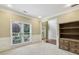 Office room with natural light, neutral walls, and built in shelving unit near the entrance at 6720 Wolford Ct, Johns Creek, GA 30097