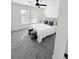 Well-lit bedroom featuring two windows, plush carpet, and a stylish ceiling fan at 1740 Langston Sw Ave, Atlanta, GA 30310