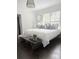 Bright primary bedroom features a large bed, hardwood floors, and natural light from multiple windows at 1740 Langston Sw Ave, Atlanta, GA 30310