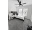 Well-lit bedroom features a single bed, soft gray carpet, and a stylish ceiling fan at 1740 Langston Sw Ave, Atlanta, GA 30310