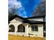 Charming white brick home with black trim and a beautifully arched entryway at 1740 Langston Sw Ave, Atlanta, GA 30310