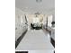 Open-concept kitchen flows into dining area, featuring white countertops and stainless steel appliances at 1740 Langston Sw Ave, Atlanta, GA 30310