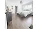 Airy bedroom with hardwood floors, a king-sized bed and a decorative bench at 1740 Langston Sw Ave, Atlanta, GA 30310