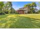 Expansive backyard featuring a well-maintained lawn, mature trees, and a covered porch perfect for relaxation and outdoor gatherings at 3527 Starwood Sw Trl, Lilburn, GA 30047