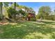 Expansive backyard featuring a well-maintained lawn, mature trees, and a cozy porch perfect for outdoor living and entertaining at 3527 Starwood Sw Trl, Lilburn, GA 30047