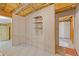 Unfinished basement area showing built-in shelving and doorways to other spaces at 3527 Starwood Sw Trl, Lilburn, GA 30047