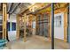 Unfinished basement with workbench, shelving, and walk-out door to the exterior at 3527 Starwood Sw Trl, Lilburn, GA 30047