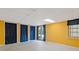 Finished basement area with yellow walls, tile ceiling, and access to the exterior at 3527 Starwood Sw Trl, Lilburn, GA 30047