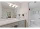 Bathroom with white vanity, bright lighting, and a view to the next room at 3527 Starwood Sw Trl, Lilburn, GA 30047