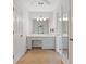Bright bathroom features a large vanity area with a neutral color palette at 3527 Starwood Sw Trl, Lilburn, GA 30047
