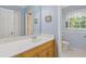Bathroom features a single sink vanity and a separate toilet room with hexagon tile at 3527 Starwood Sw Trl, Lilburn, GA 30047