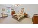 Cozy bedroom with floral bedding, ceiling fan, and natural light at 3527 Starwood Sw Trl, Lilburn, GA 30047