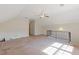 Spacious bonus room with neutral carpet, ceiling fan, and staircase railing at 3527 Starwood Sw Trl, Lilburn, GA 30047