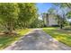 Long driveway leading to a home surrounded by lush landscaping and mature trees at 3527 Starwood Sw Trl, Lilburn, GA 30047