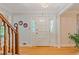 Bright foyer with hardwood floors, a white front door with glass accents, and decorative plates at 3527 Starwood Sw Trl, Lilburn, GA 30047