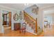 Traditional foyer with hardwood floors, staircase with wood banister, and decorative wall art at 3527 Starwood Sw Trl, Lilburn, GA 30047