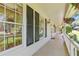 Inviting covered front porch with white columns, hanging flower baskets and black shutters at 3527 Starwood Sw Trl, Lilburn, GA 30047