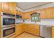 Well-lit kitchen with stainless steel oven, microwave, and ample cabinet space at 3527 Starwood Sw Trl, Lilburn, GA 30047