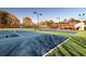 Community tennis courts featuring night lighting, green screens and covered social area at 3527 Starwood Sw Trl, Lilburn, GA 30047
