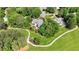 Expansive home with a pool, circular driveway, and lush landscaping, surrounded by mature trees and a golf cart path at 5045 Harrington Rd, Johns Creek, GA 30022