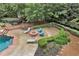 Backyard area with fire pit, lounge chairs, meticulous landscaping, and mature trees at 5045 Harrington Rd, Johns Creek, GA 30022