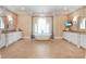 Elegant bathroom featuring double vanities, soaking tub, chandelier, decorative wallpaper, and television at 5045 Harrington Rd, Johns Creek, GA 30022