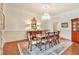 Formal dining room with a large table, chandelier, hardwood floors, and elegant decor at 5045 Harrington Rd, Johns Creek, GA 30022