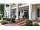 Grand entrance with brick steps and white columns, leading to a welcoming front door with decorative accents at 5045 Harrington Rd, Johns Creek, GA 30022