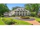 Elegant two-story home with a circular driveway and fountain, showcasing its classic architectural details at 5045 Harrington Rd, Johns Creek, GA 30022